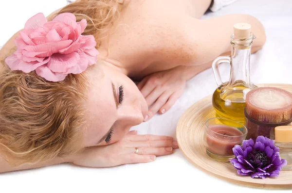 Woman lying with spa products — Stock Photo, Image