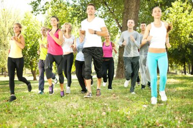 Large group jogging in park