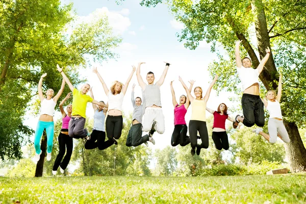 Large group of teens jumping together — Stock Photo, Image