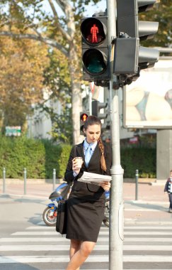 Businesswoman leaning on the traffic light clipart