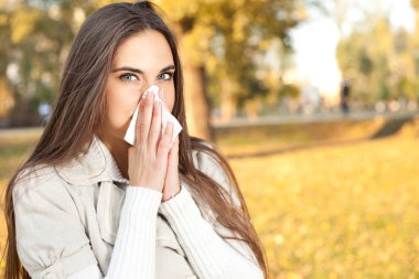 Woman blowing her nose clipart