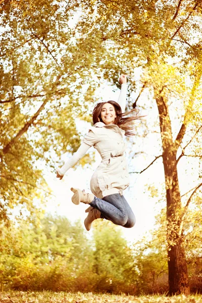 Jump in autumn park — Stock Photo, Image
