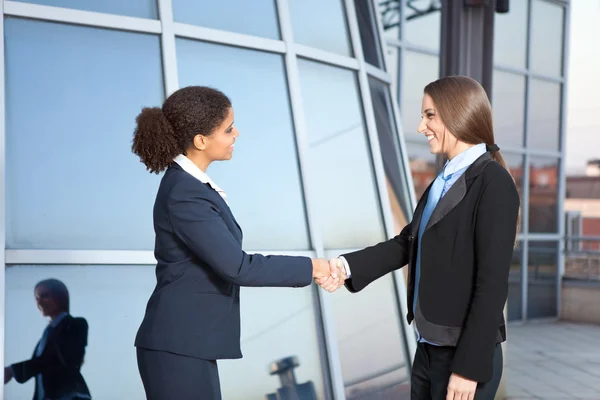 Businesswomen shaking hands Stock Photo