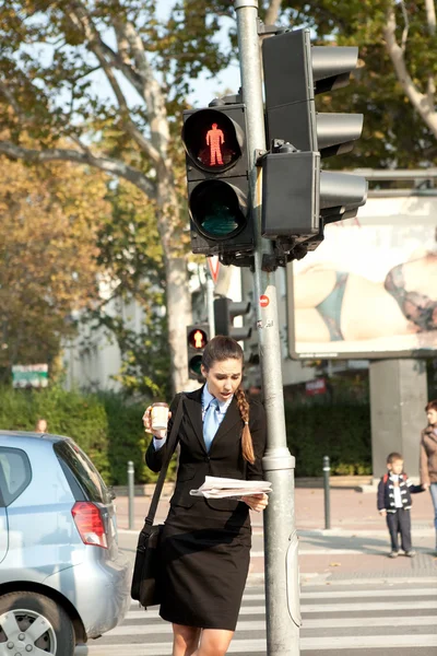 Businesswoman on pedestrian crossing