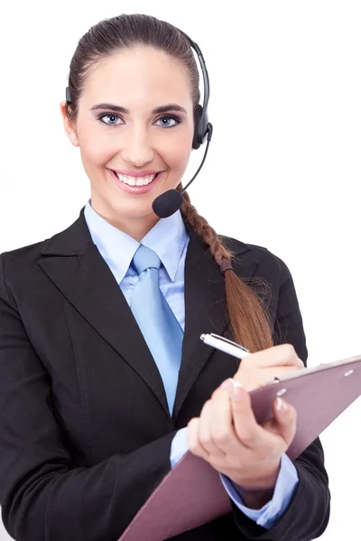 Geschäftsfrau mit Headset macht Notiz — Stockfoto