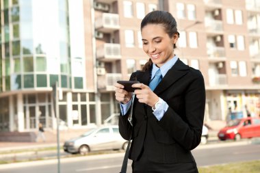 Businesswoman with smart phone clipart