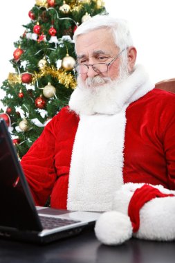 Modern Santa using laptop clipart