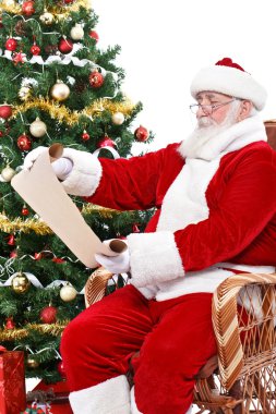 Santa Claus reading wish list clipart