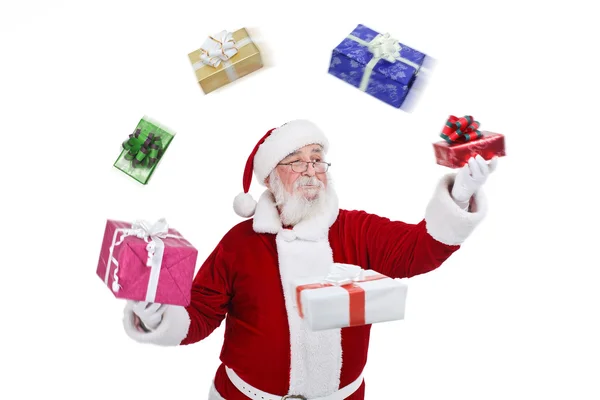 Santa Claus throwing and playing with presents Stock Image