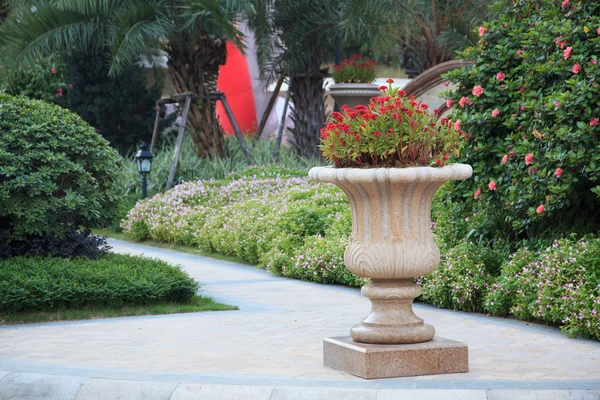 Ornamental stone flowerpot in garden — Stock Photo, Image
