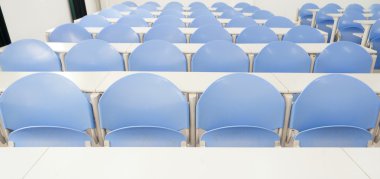 Desks and chairs in a modern training room clipart