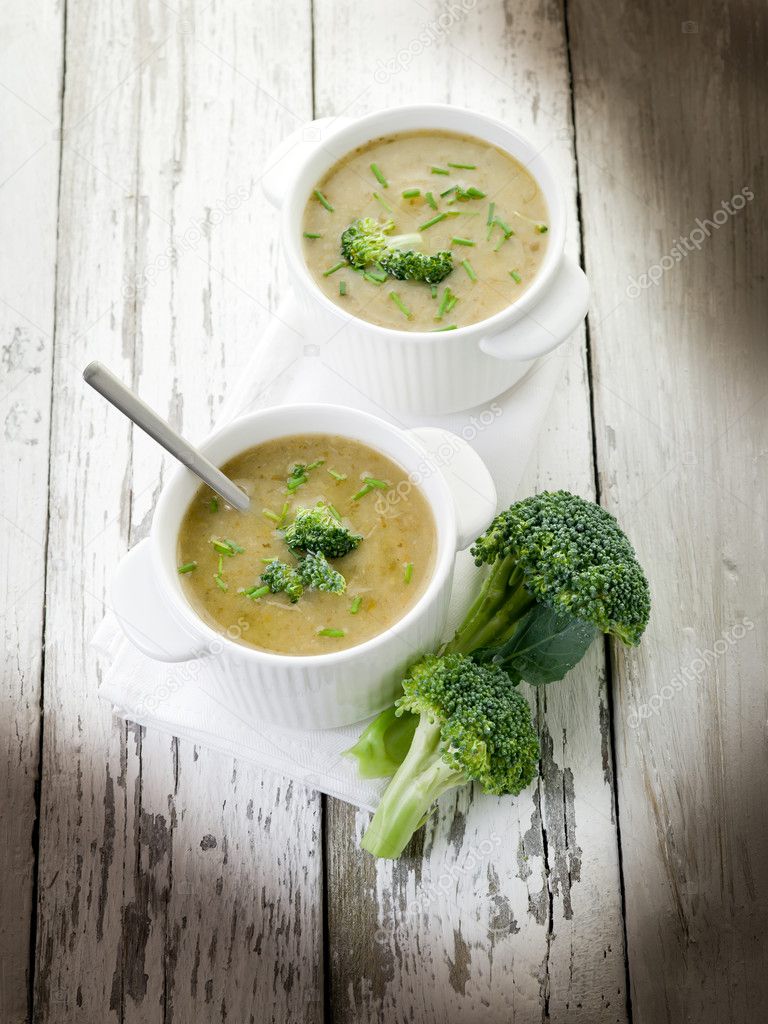 Broccoli soup on bowl over wood background