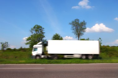 Truck traveling on the highway, blured motion clipart