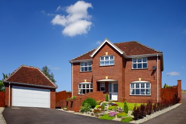 House with garage on a blue sky clipart