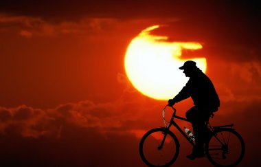 Cycling at sunset clipart