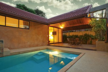 Panoramic view of nice summer house patio with swimming pool clipart