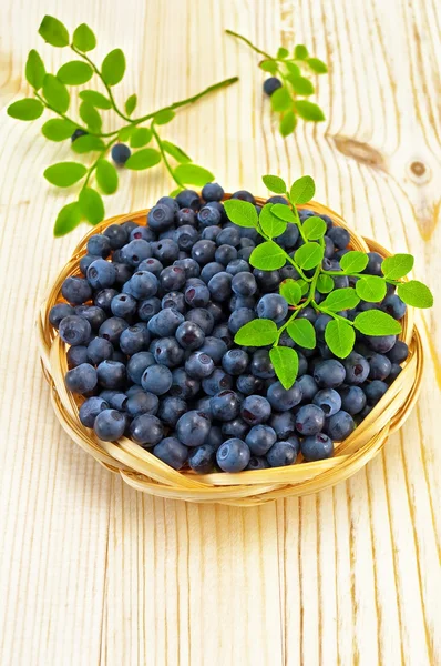 Blueberries in a wicker tray on a blackboard — Stock Photo, Image
