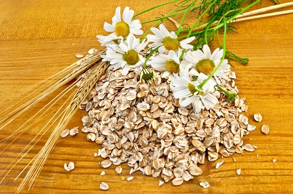Rye flakes with daisies — Stock Photo, Image