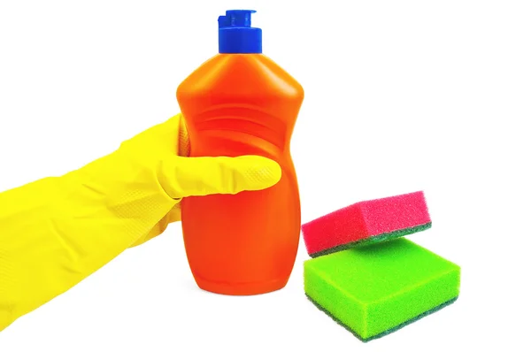 Botella de naranja con guante amarillo y esponjas — Foto de Stock