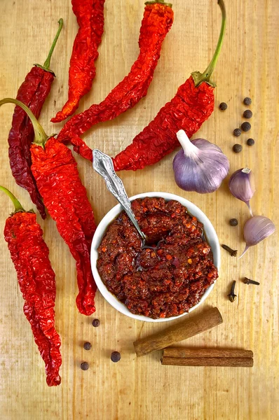 Adjika with dried hot peppers — Stock Photo, Image