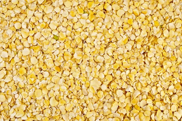 The texture of the yellow pea flakes — Stock Photo, Image