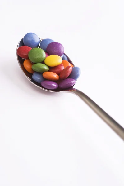Spoon with sweets — Stock Photo, Image