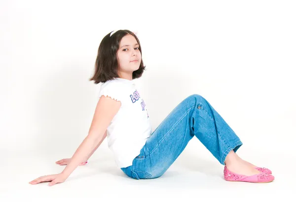 The girl sits on a white background — Stock Photo, Image