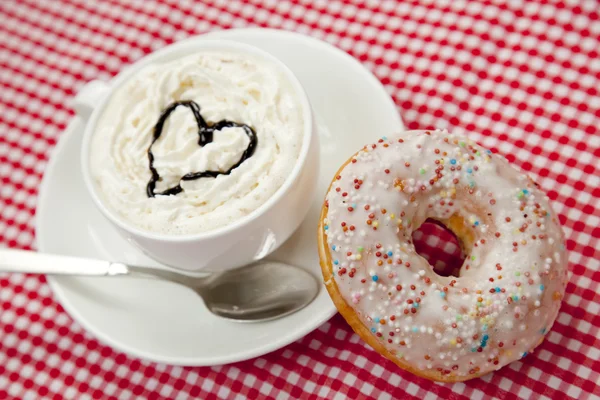 Donuts with coffee on table. — Stock Photo, Image