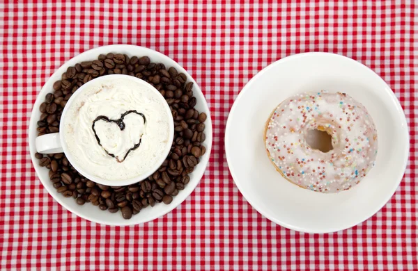 Donuts with coffee on table. — Stock Photo, Image