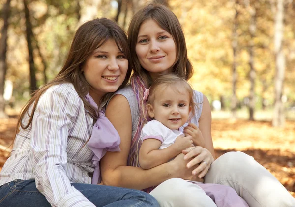 Girlfriends and little child at the park. — Stock Photo, Image