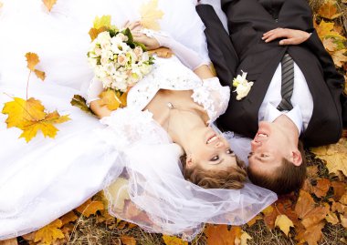 Couple liying down at the park clipart