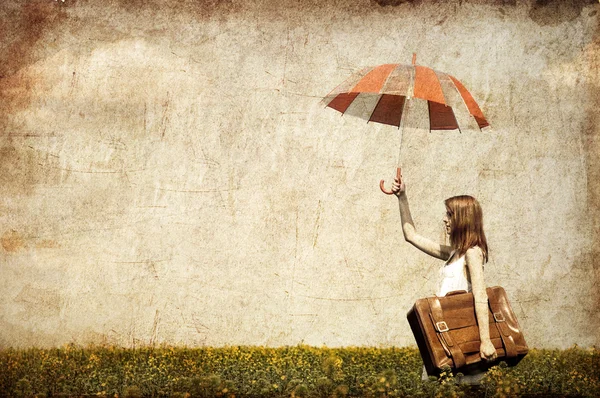 Redhead enchantress with umbrella and suitcase — Stock Photo, Image