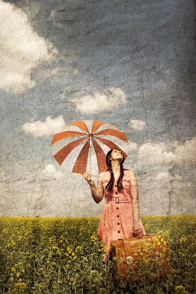 stock image Brunette enchantress with umbrella and suitcase