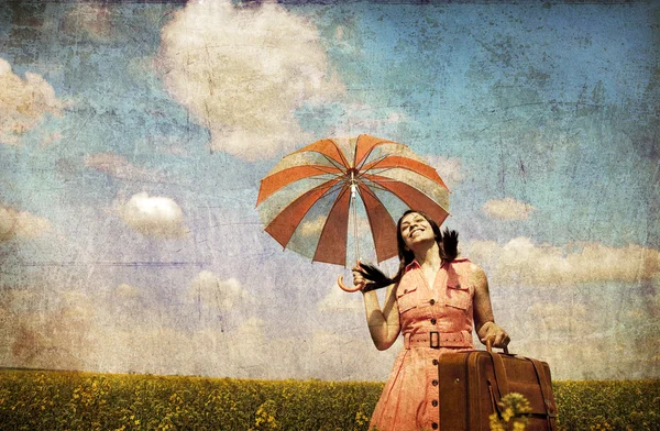 Brünette Zauberin mit Regenschirm und Koffer — Stockfoto