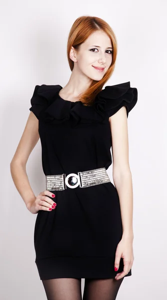 Young red-haired lady in black dress posing — Stock Photo, Image