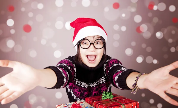 Funny girl in glasses with christmas gifts. — Stock Photo, Image