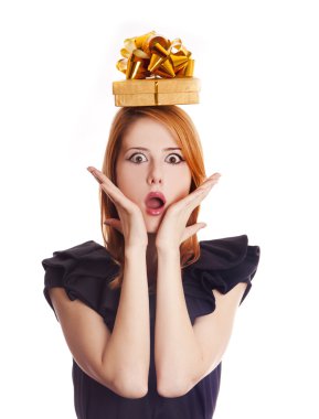 Red-haired girl in dress with present box over head