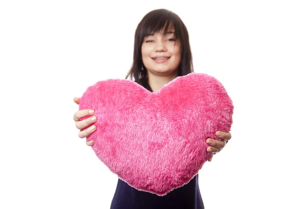 Beautiful brunette girl with toy heart. — Stockfoto