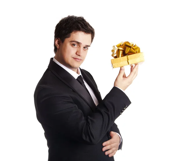 A man holding present box in formal black tux — Stock Photo, Image