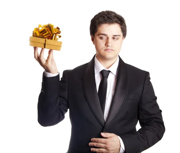 A man holding present box in formal black tux — Stok fotoğraf