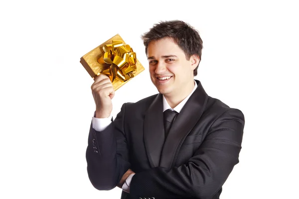 A man holding present box in formal black tux — Stok fotoğraf