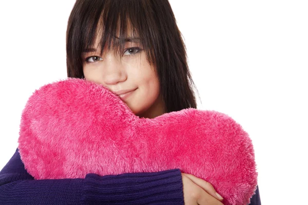 Beautiful brunette girl with toy heart. — Stock Photo, Image