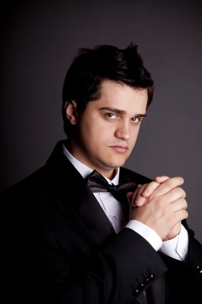 Style young brunette man with black tuxedo. — Stock Photo, Image