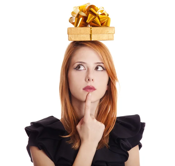Beautiful red-haired girl with present box over head. — Stockfoto