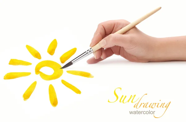 Hand with brush drawing sun — Stock Photo, Image