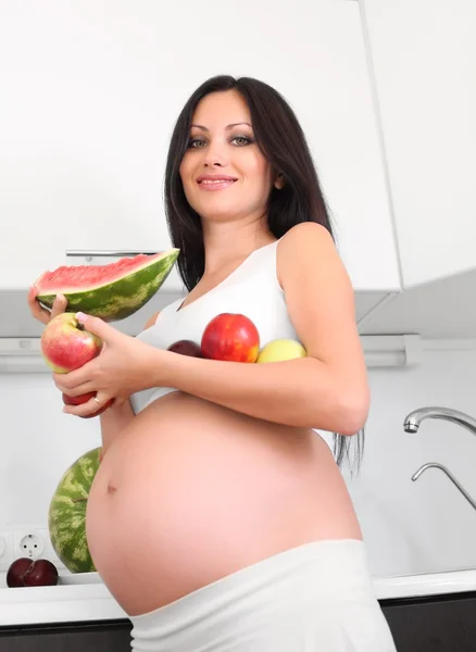 Pregnant woman on kitchen Stock Photo