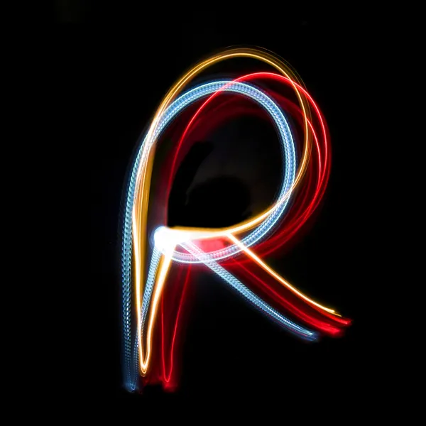 Letter R made from brightly coloured neon lights — Stock Photo, Image