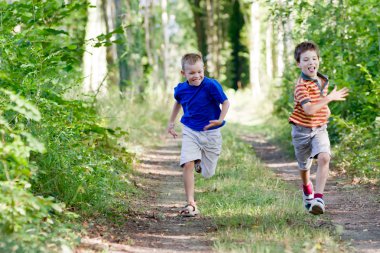 Young children running in nature clipart