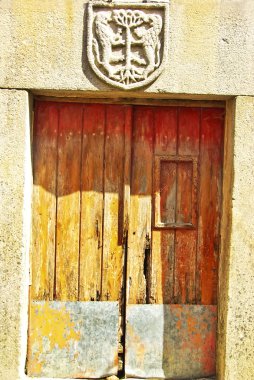 Aged wood door in medieval village,Portugal. clipart