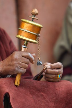 Prayer wheel in man's hand clipart